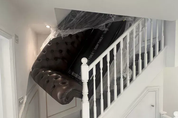 A photo of a sofa stuck on the stairs