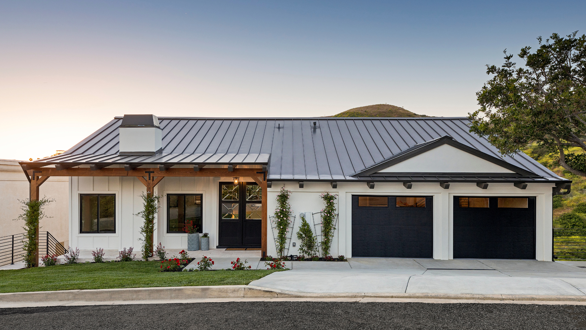 A modern house with a swimming pool and a lot of windows.