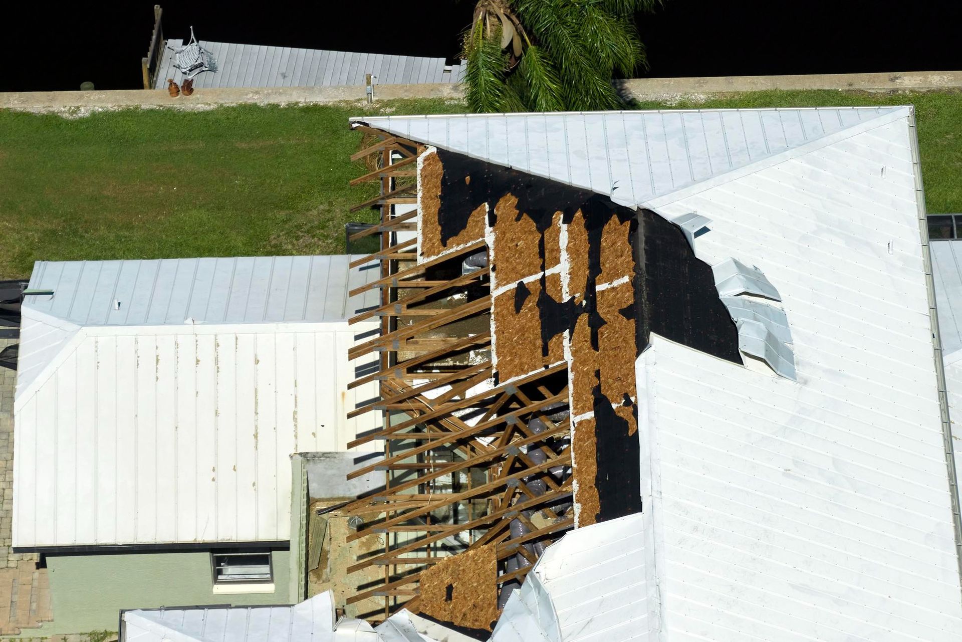 An aerial view of a roof that has been damaged by a storm
