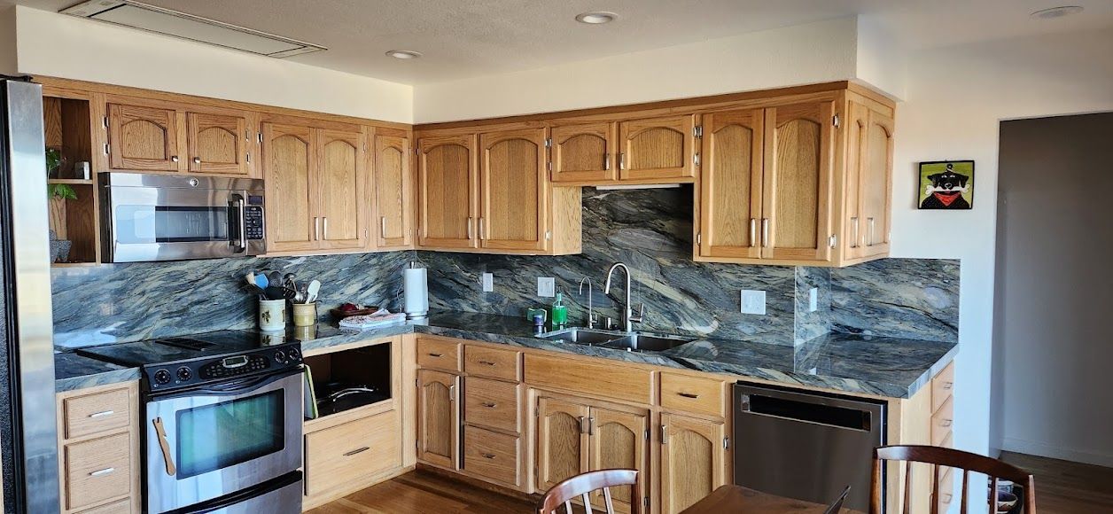 A kitchen with stainless steel appliances and wooden cabinets
