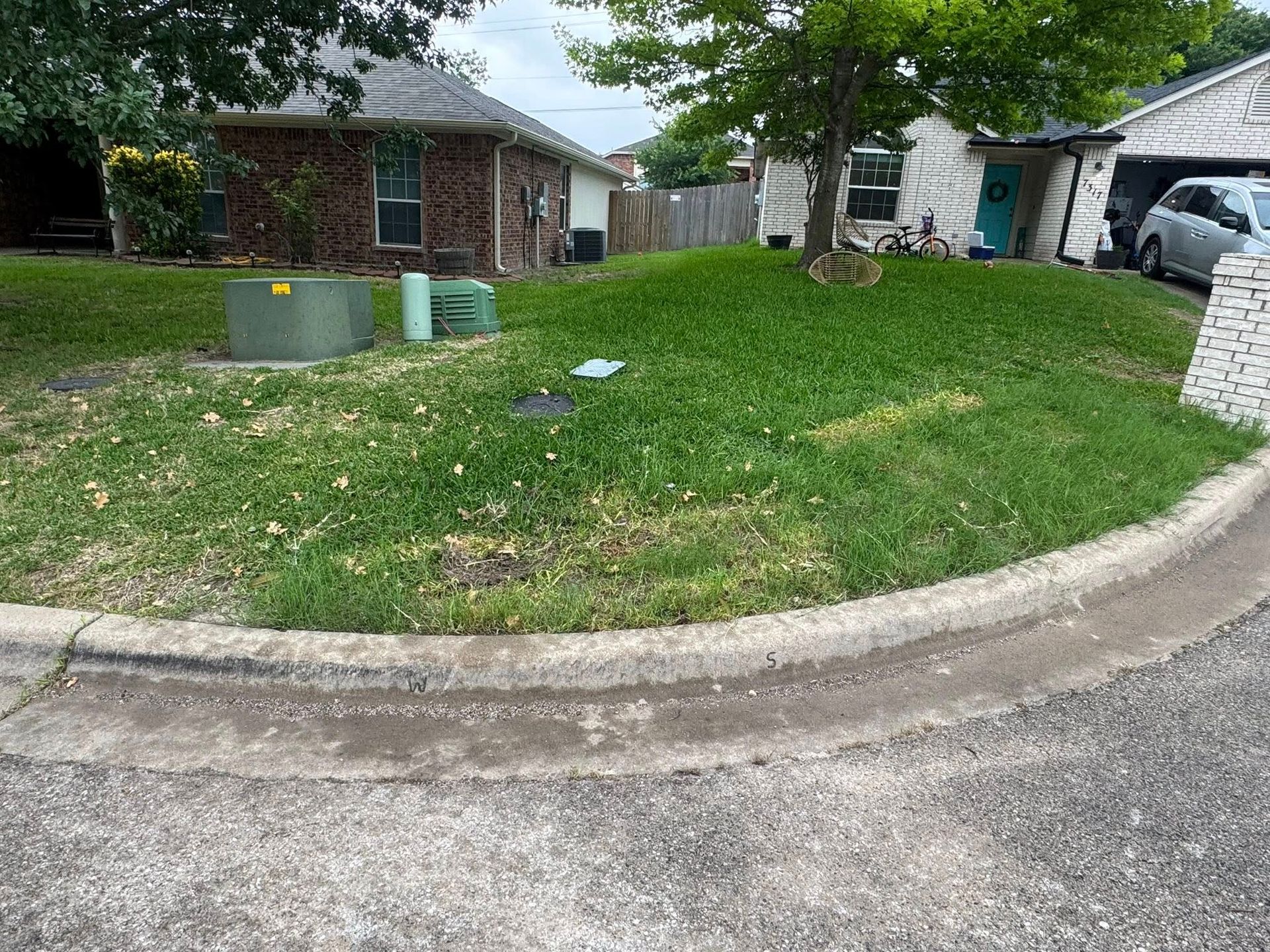 A house with a large grassy hill in front of it.