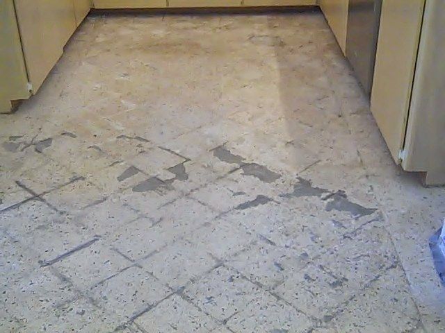 Damaged, tiled kitchen floor