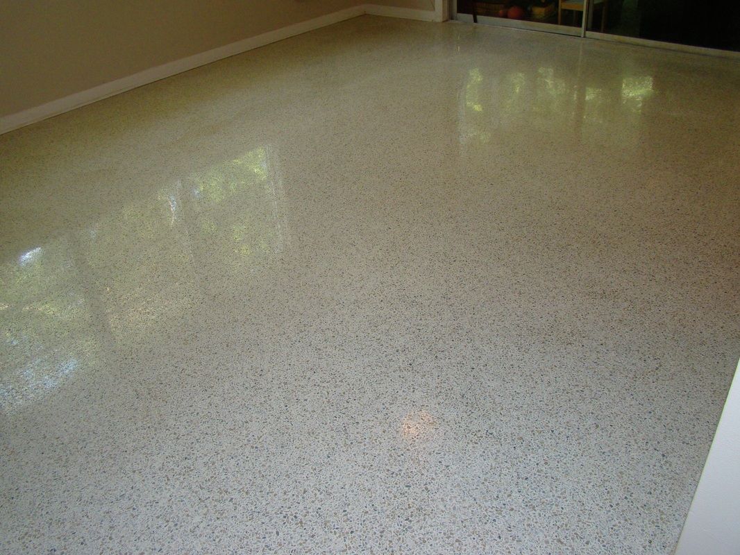 Polished concrete floor reflecting light from windows