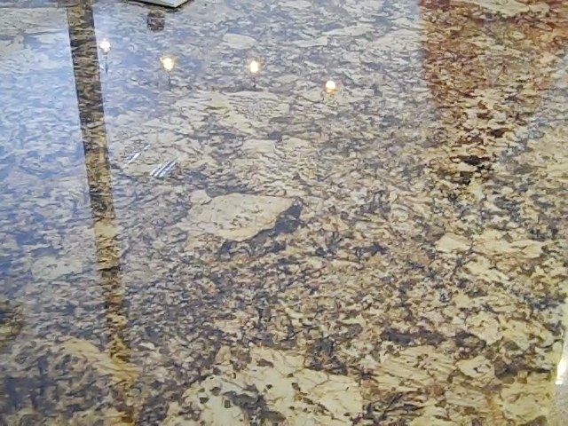 Shiny granite countertop with tan