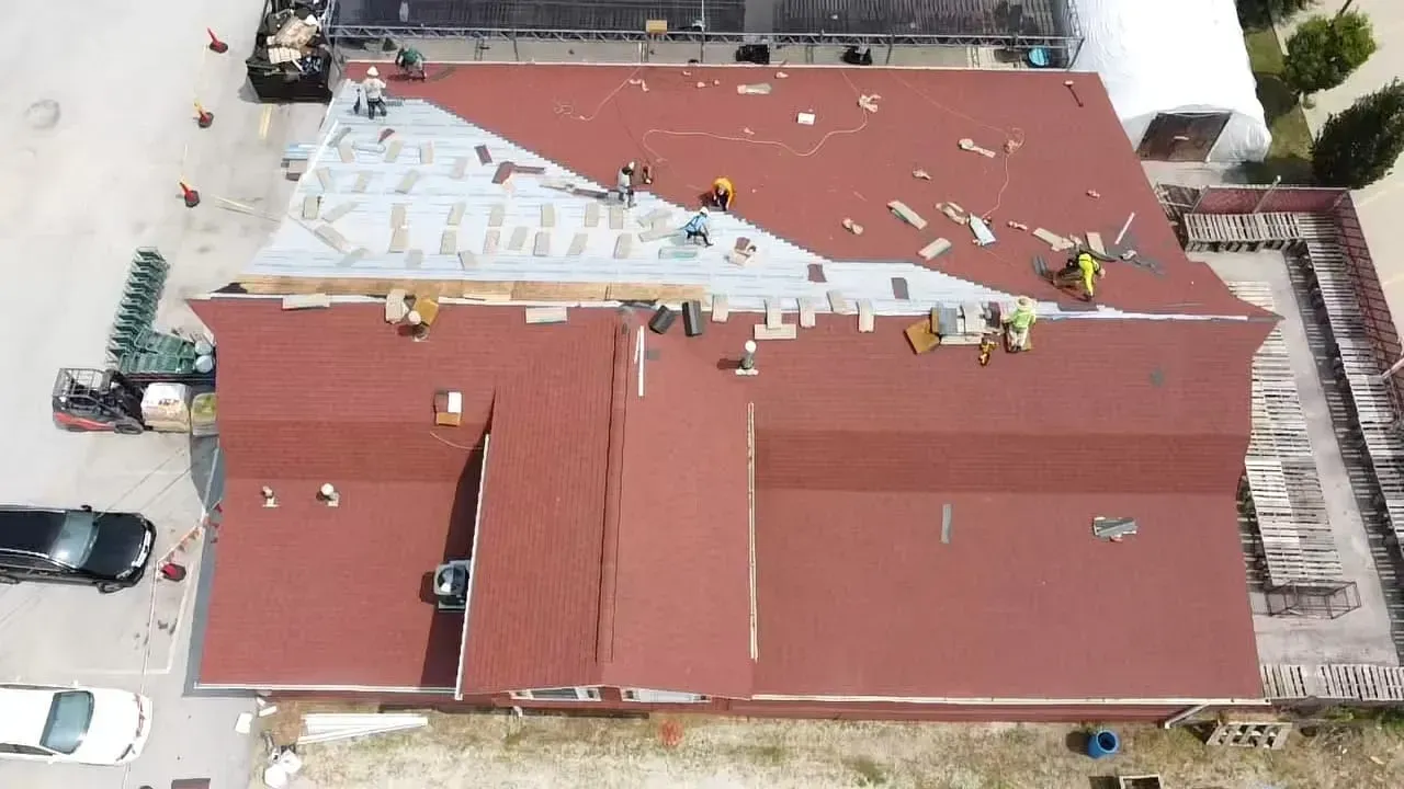 An Aerial View of A Building Under Construction with A Red Roof | Fayetteville, NC | Danny Odom Roofing