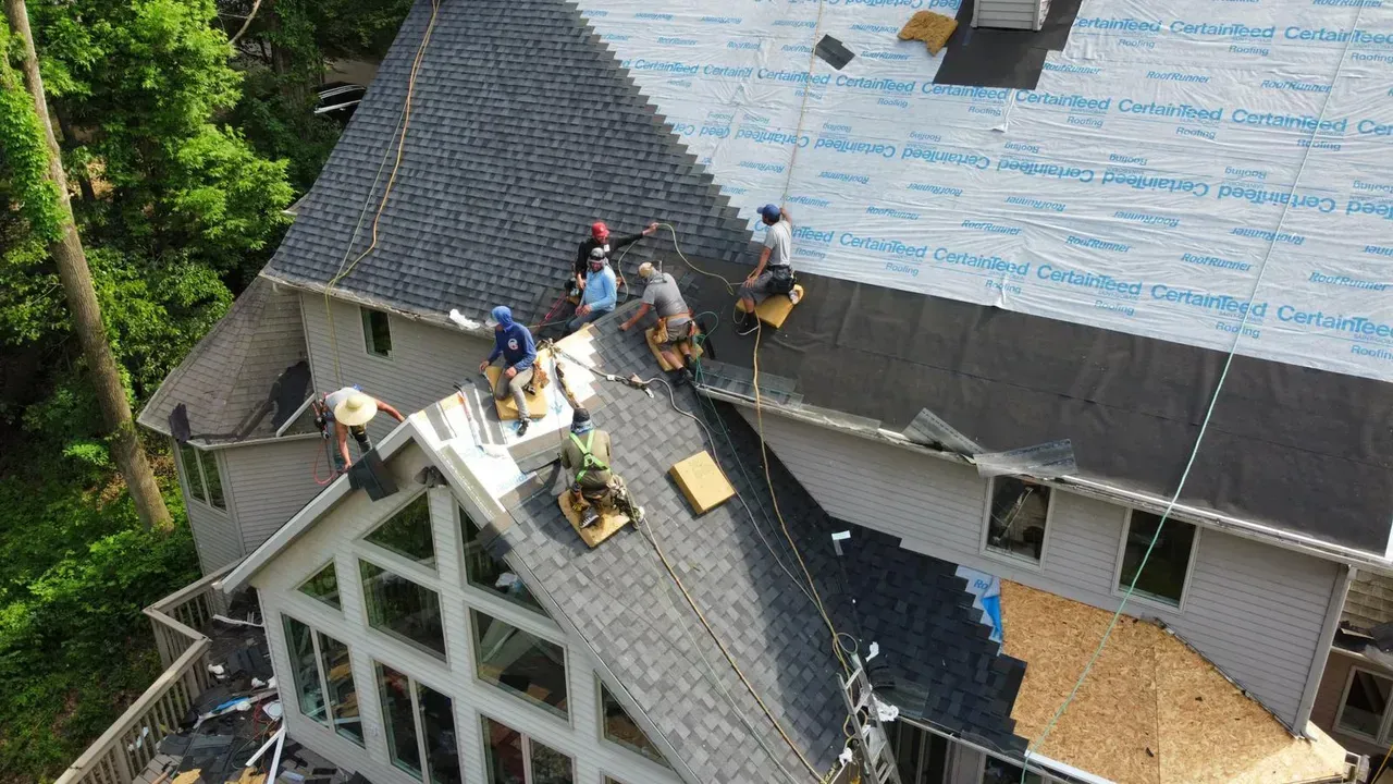 A Group of People Are Working on The Roof of A House | Fayetteville, NC | Danny Odom Roofing