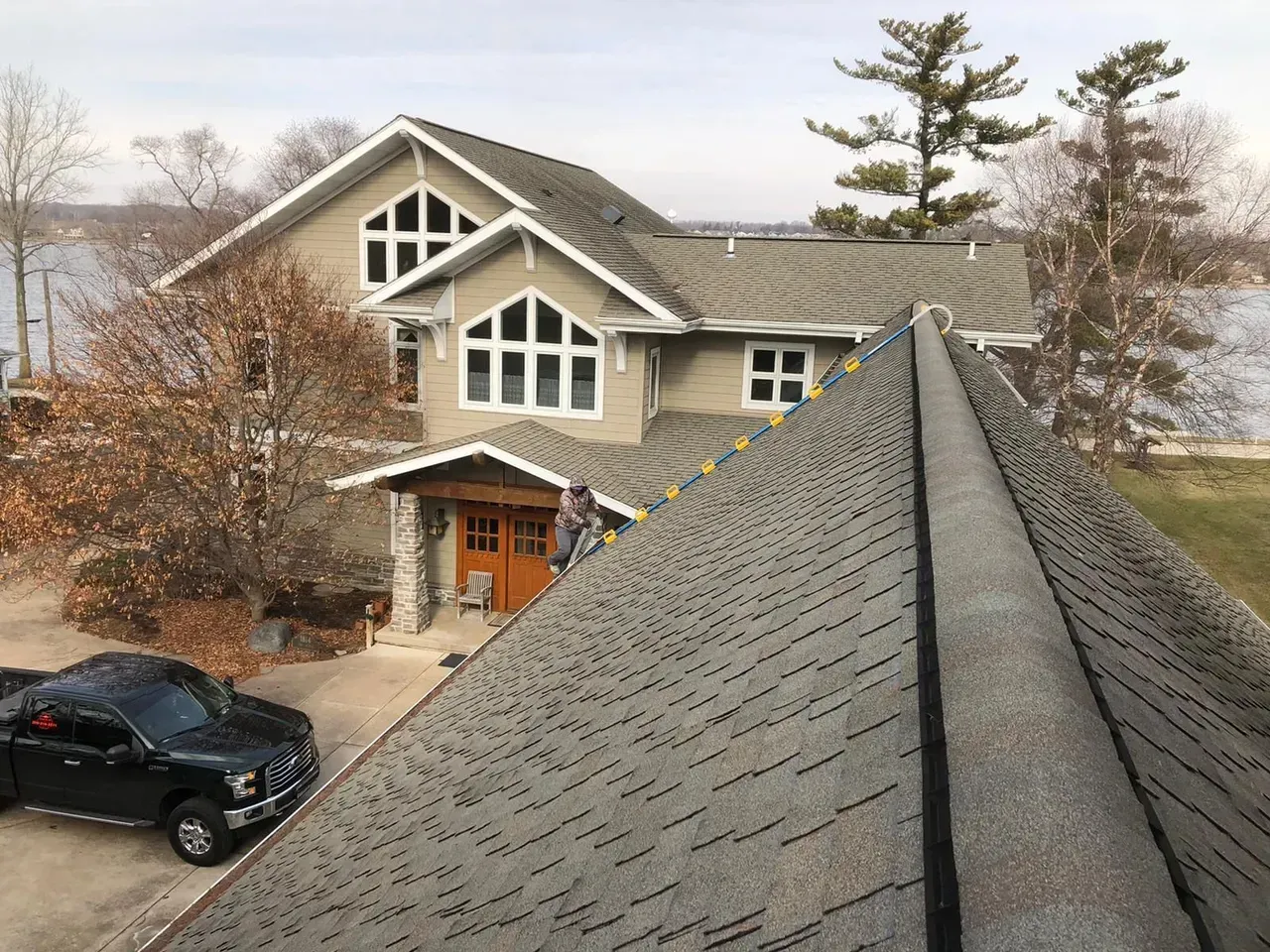 A Large House with A Truck Parked in Front of It | Fayetteville, NC | Danny Odom Roofing