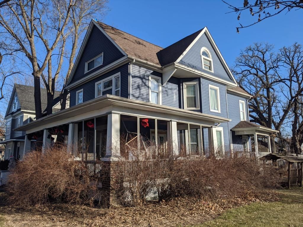 A Large House with A Large Porch and A Blue Sky in The Background | Fayetteville, NC | Danny Odom Roofing