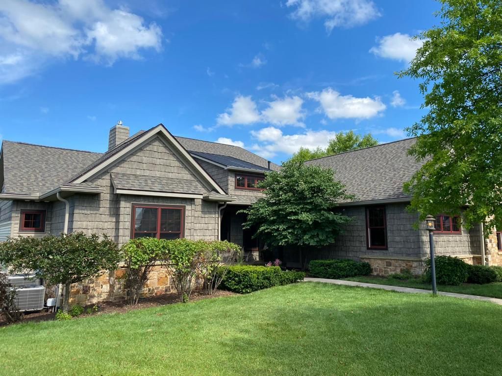 A Large House with A Gray Roof and A Large Lawn in Front of It | Fayetteville, NC | Danny Odom Roofing