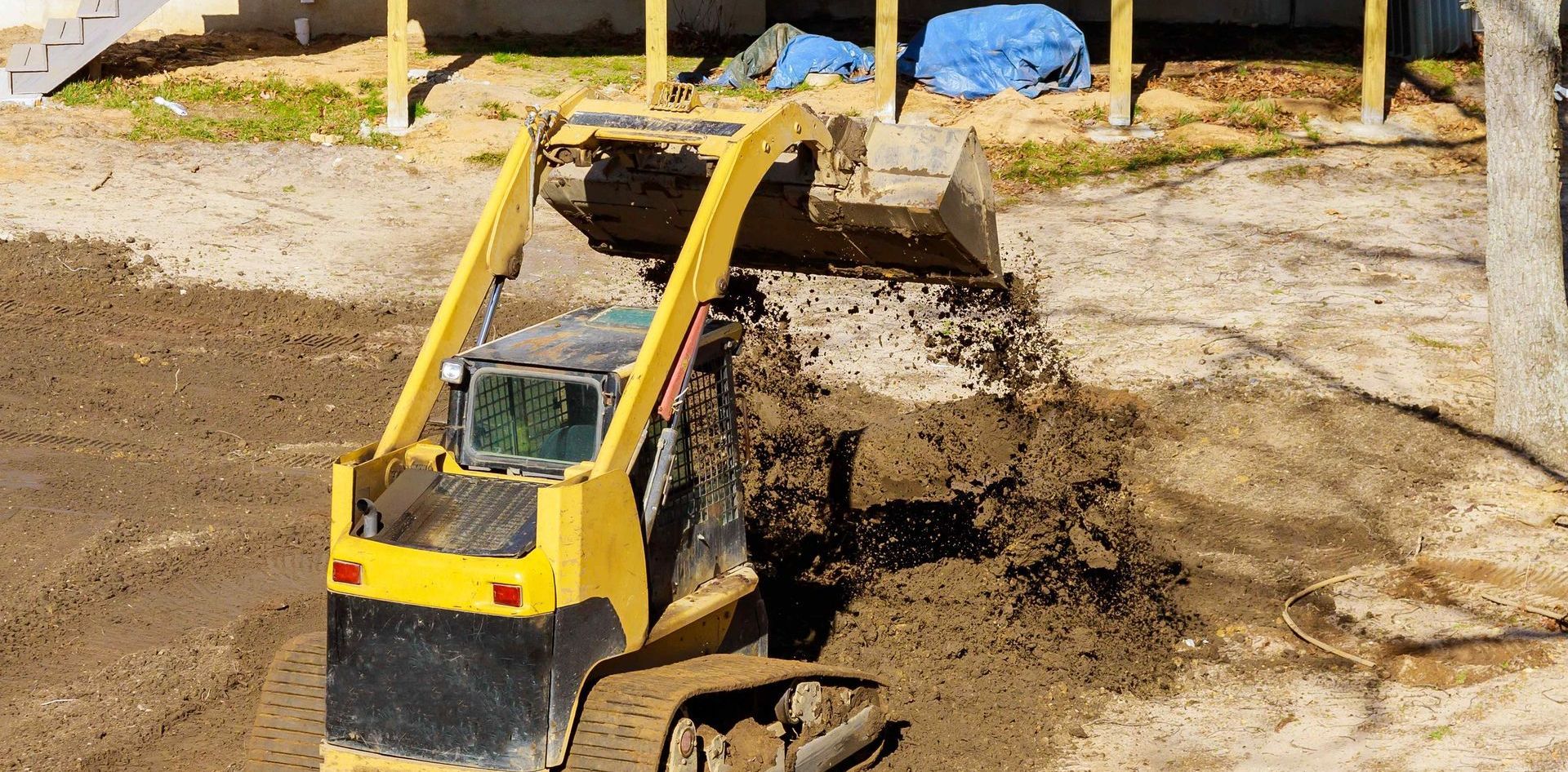 Excavator Grading Yard For Better Drainage