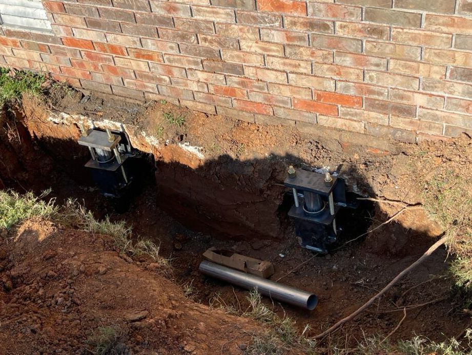 Helical Piers Installed Supporting Foundation Of House