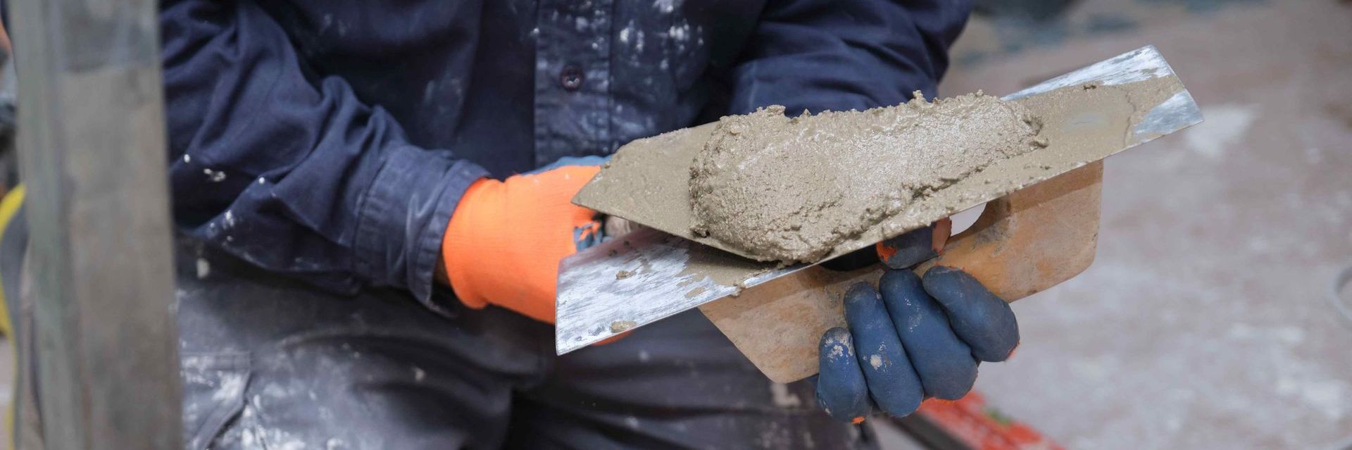 Man Preparing Cement To Repair Cracks In Concrete Foundation