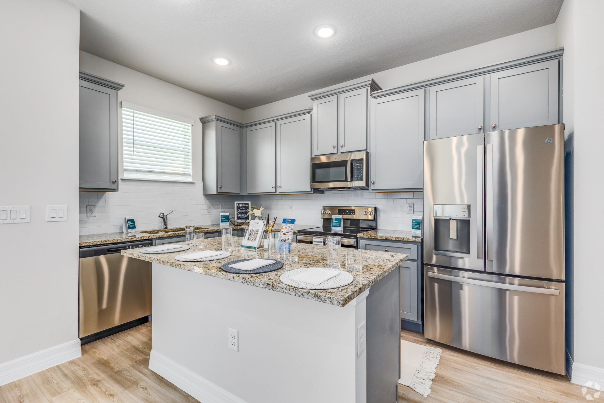 A kitchen with stainless steel appliances and granite counter tops.