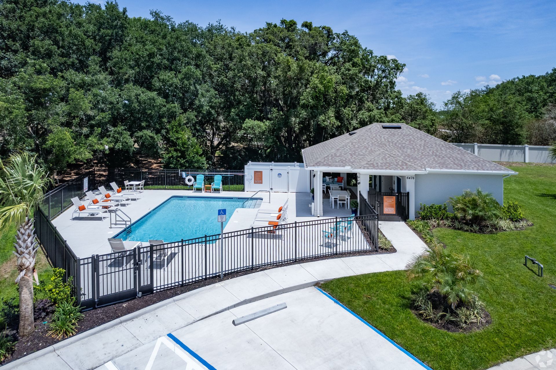 An aerial view of a large swimming pool surrounded by a fence.