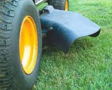 a close-up of a tire on a lawn mower on a lush green field, haulin property services llc