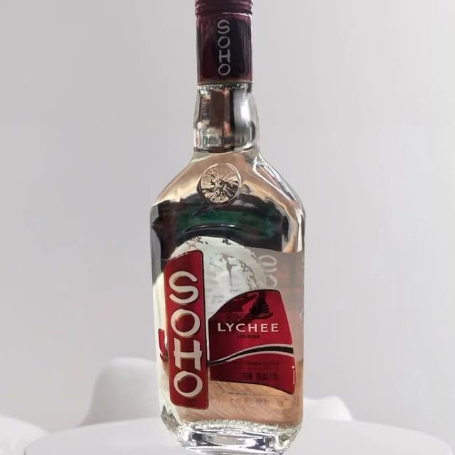 A bottle of lychee liquor is sitting on a table