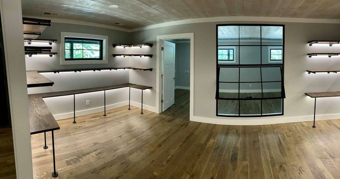A large room with a lot of shelves and a window.