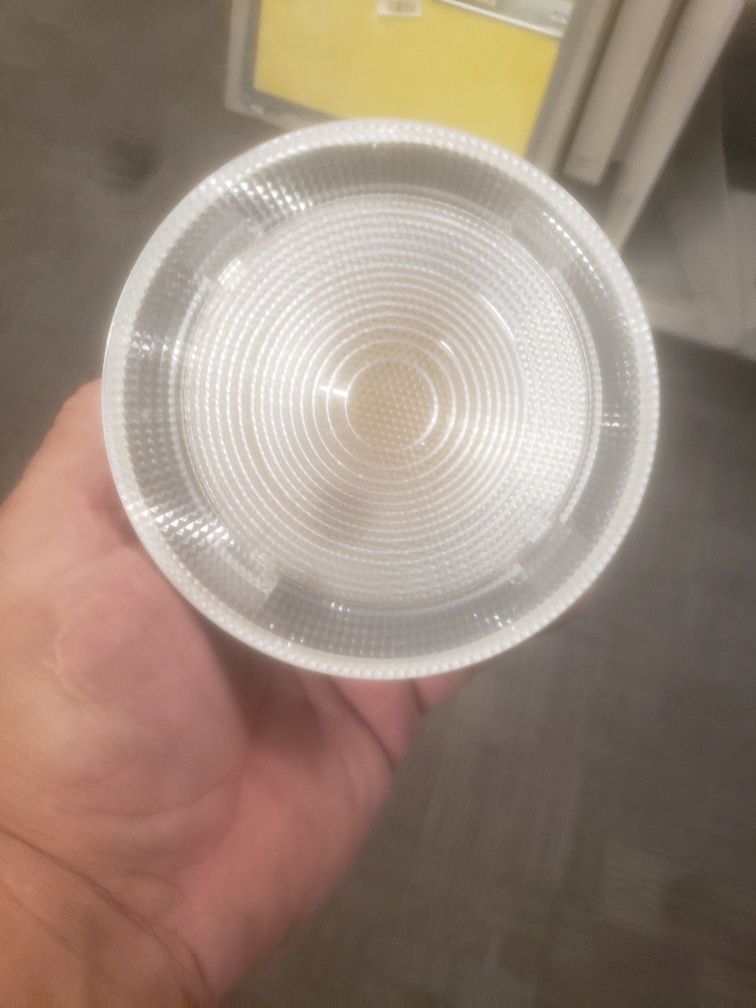 A person is holding a light bulb in their hand.