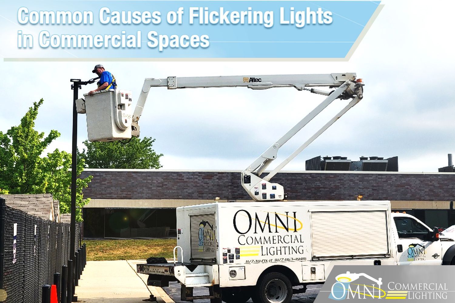 A man in a bucket is working on a street light.