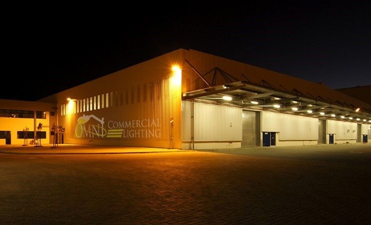 A large building with a lot of lights on it is lit up at night.