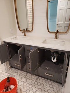 A bathroom with two sinks and two mirrors