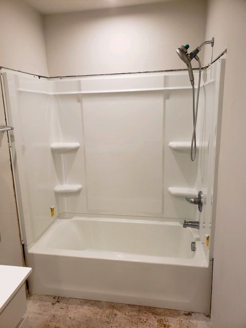 A bathtub with a shower head attached to it in a bathroom.