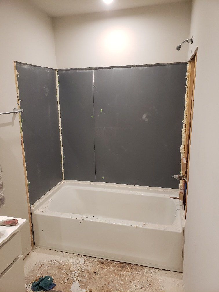 A bathtub is being remodeled in a bathroom.