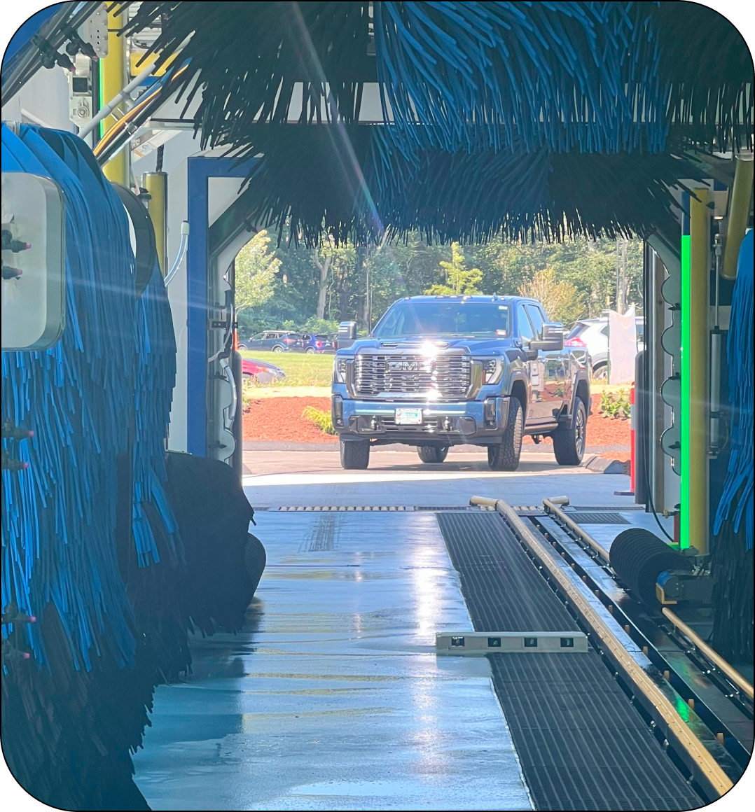 A truck is driving through a car wash tunnel.