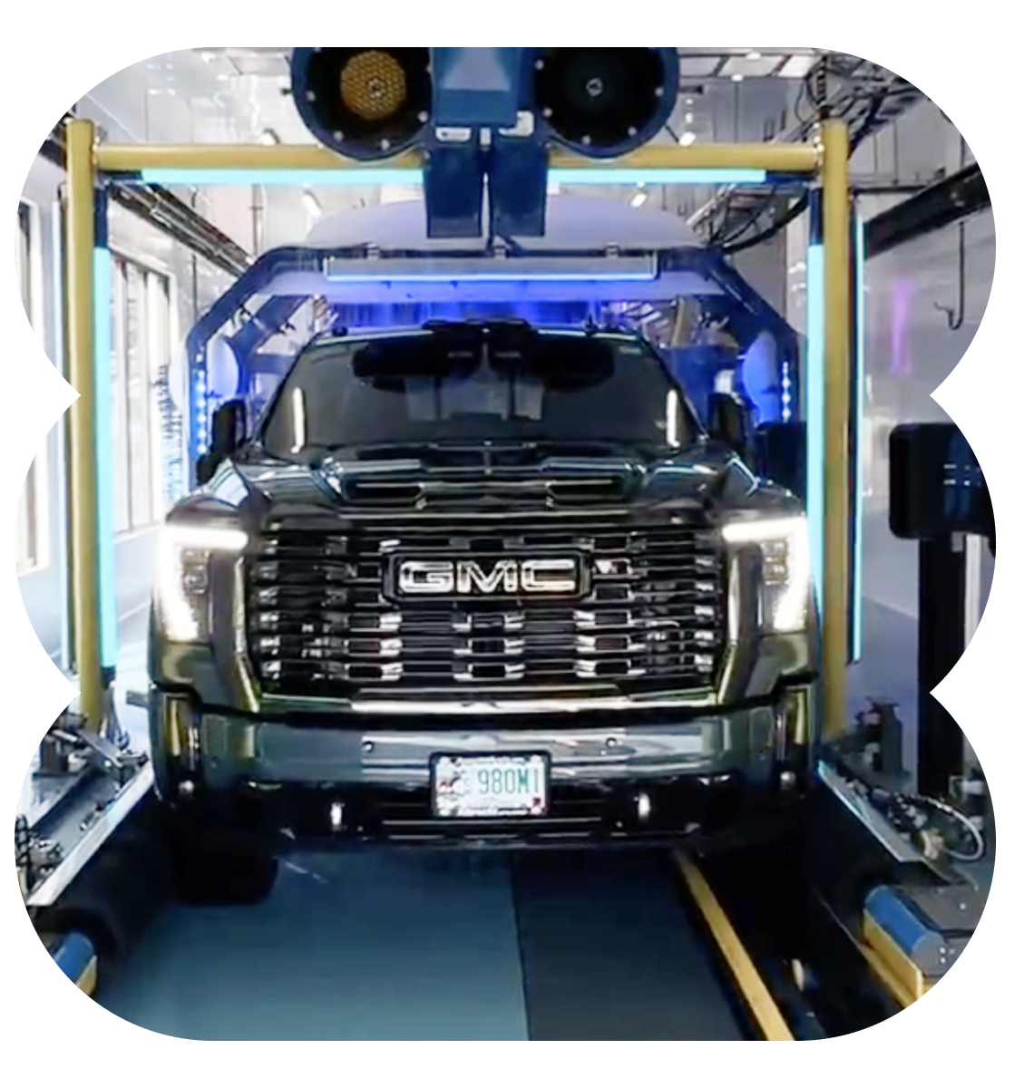 A gmc truck is going through a car wash