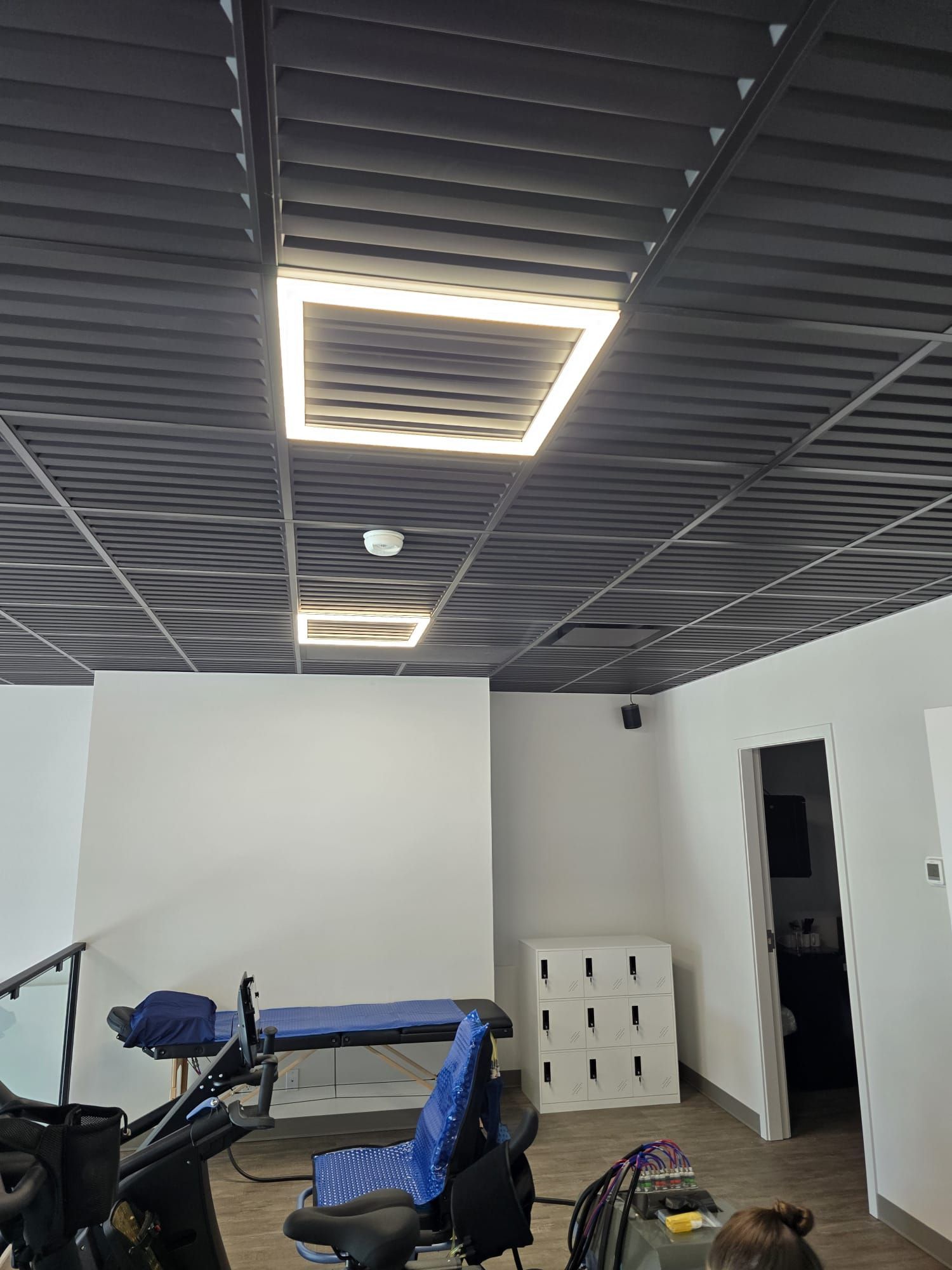 Interior view of the ceiling and speciality lights that shine around certain ceiling panels inside The Smart Fit Method