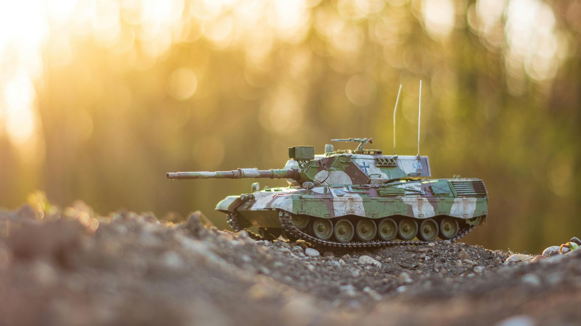 Scale model tank on rocks with grassy background