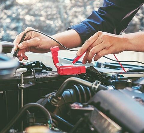 Car Mechanic Testing Battery — Auto Electrical Repairs In Mullumbimby, NSW