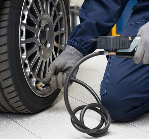 Mechanic Checking Tyre Pressure — Suspension Repairs In Mullumbimby, NSW