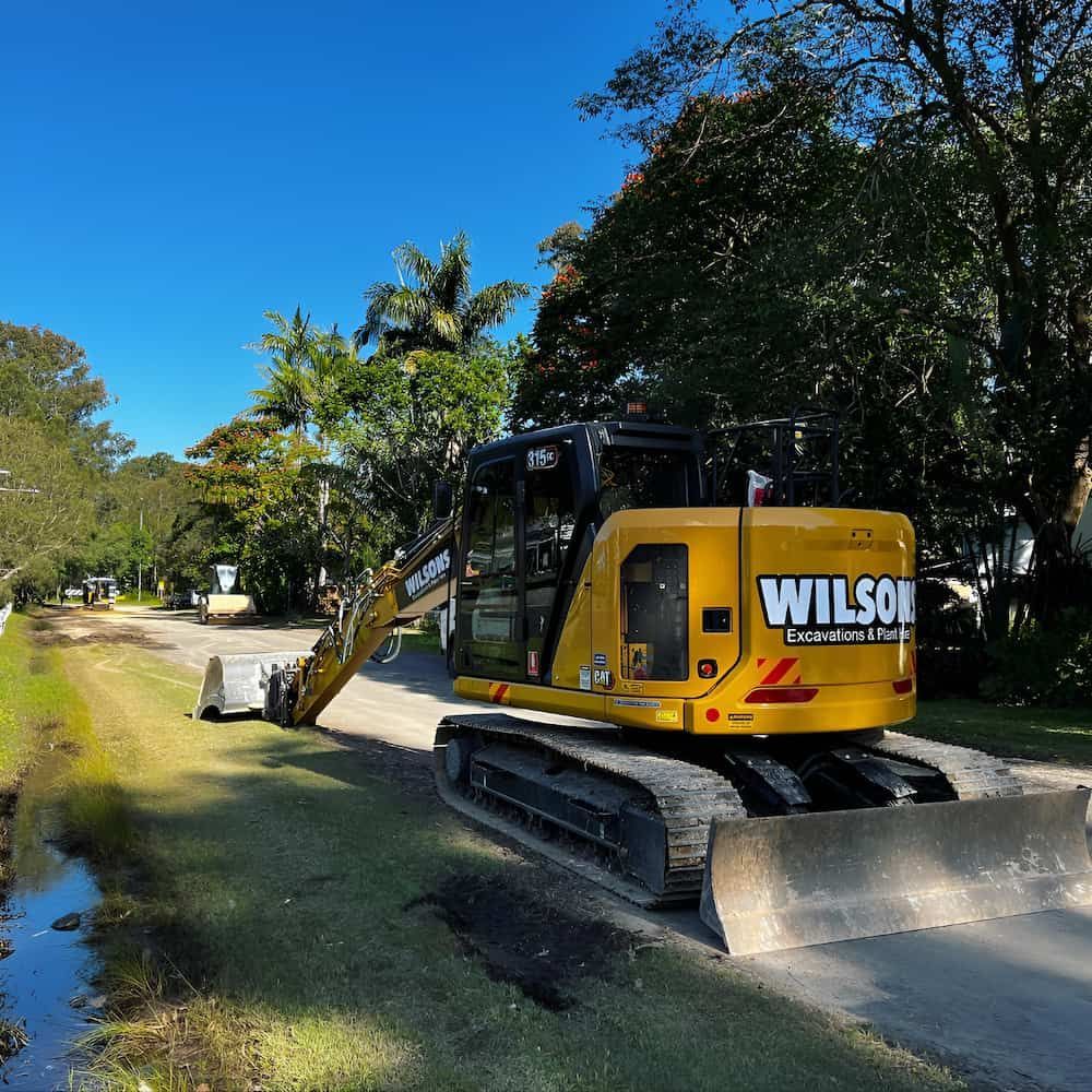 A Wilson Bulldozer Is Parked On The Side Of A Road — Wilsons Excavations & Plant Hire in Ballina, NSW