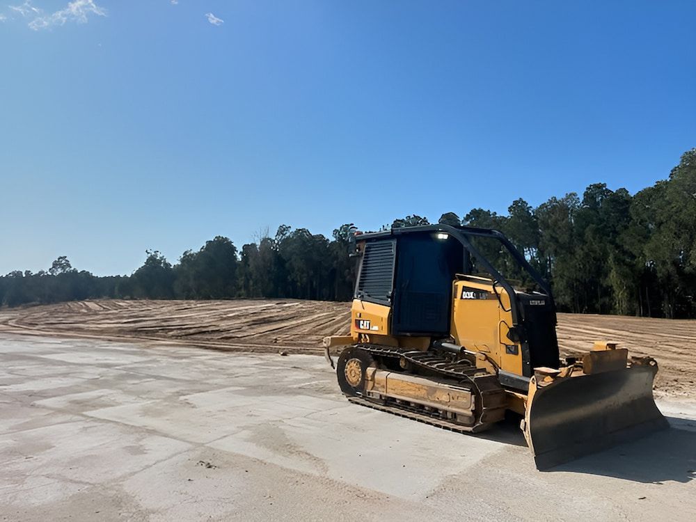 A Bulldozer Is Parked In The Middle Of A Dirt Field — Wilsons Excavations & Plant Hire in Myocum, NSW