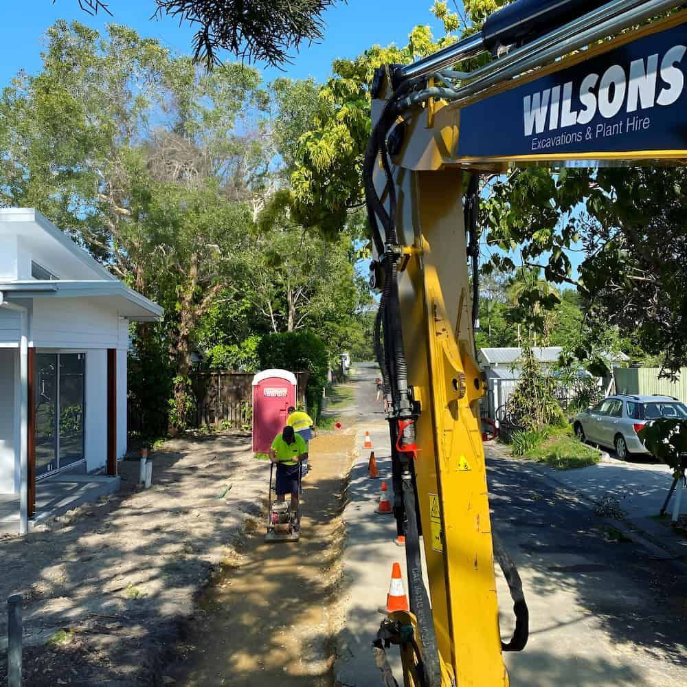 A Yellow Excavator With The Word Wilsons On It — Wilsons Excavations & Plant Hire in Ballina, NSW