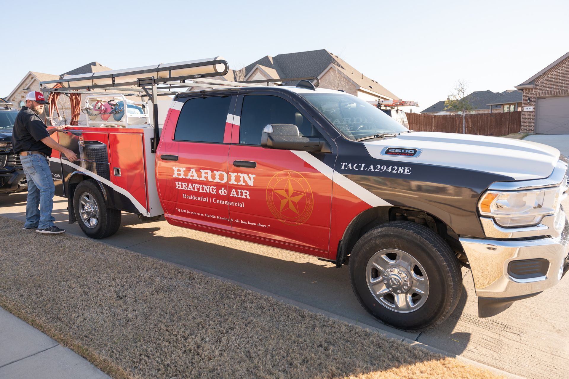 Truck with red and white branding parked, a person by the side.