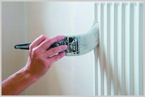 One of our team painting a radiator