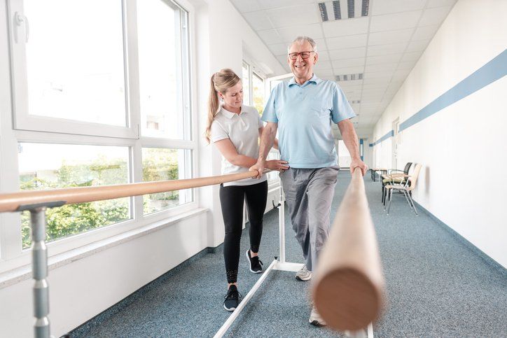 Senior Patient and physical therapist in rehabilitation walking exercises