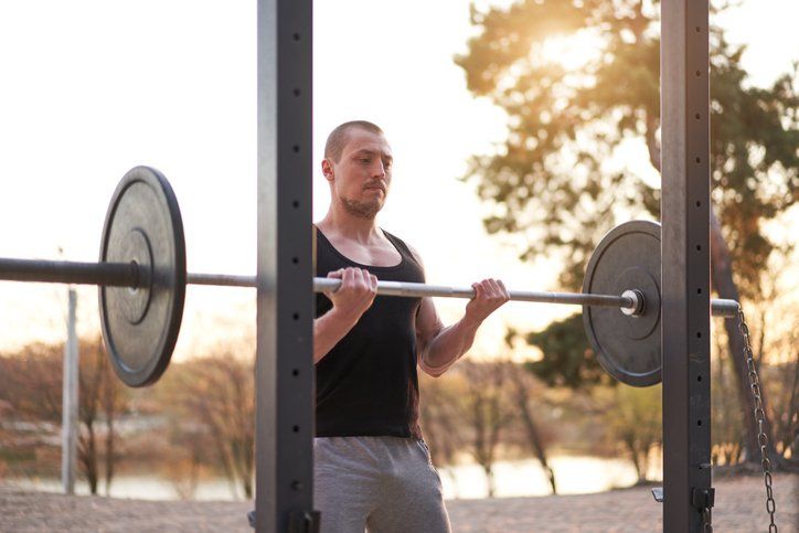 Man with barbell outdoor gym