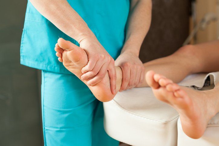 Doctor examining  patient's foot