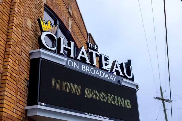a sign for the chateau on broadway is on a brick building .