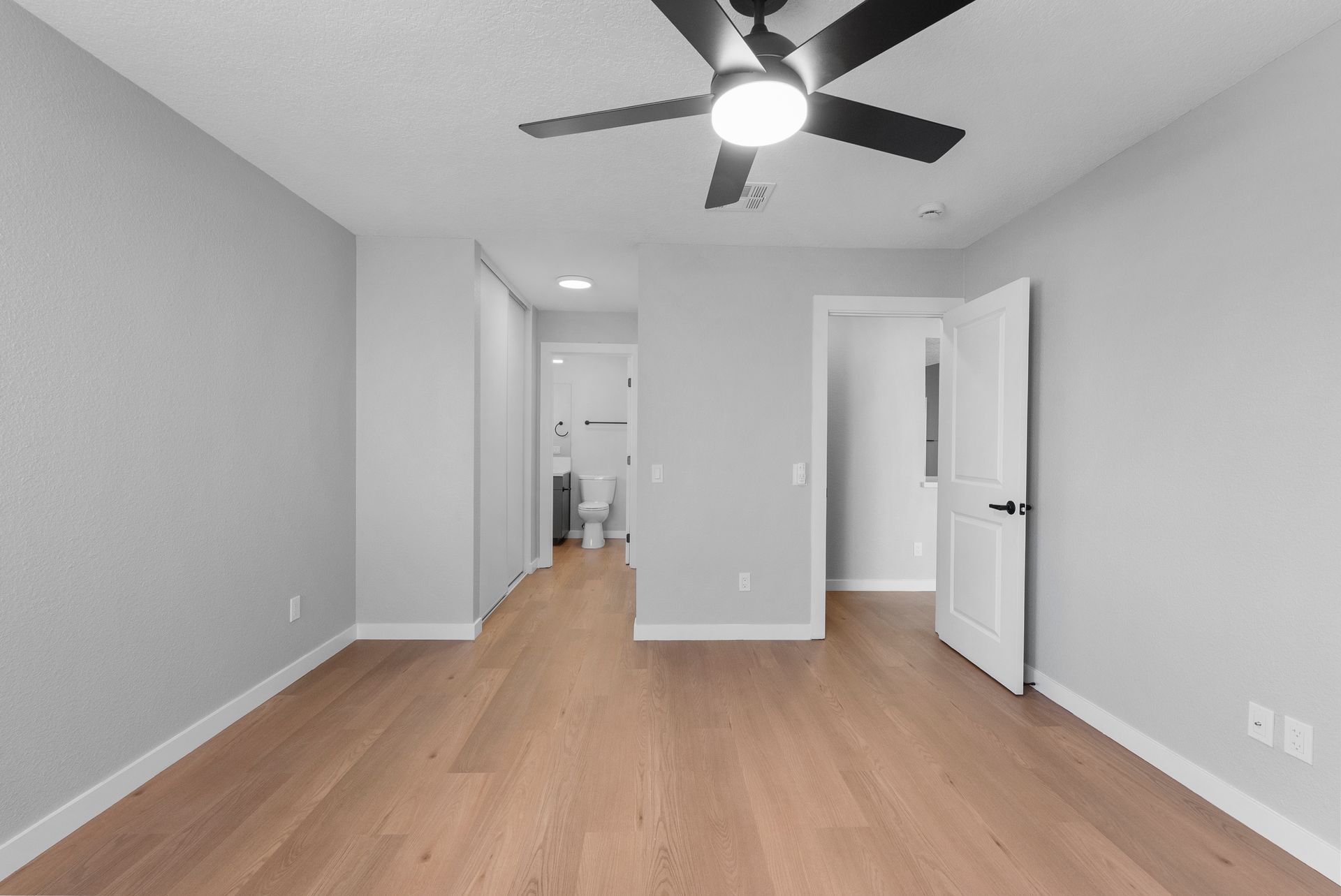 bedroom with open door to bathroom