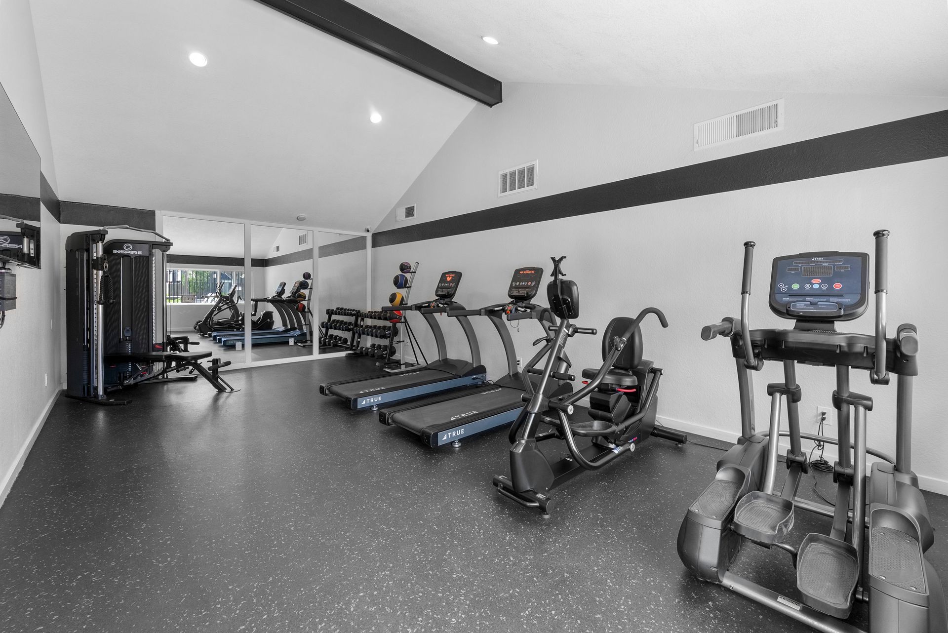 fitness center with weights and cardio equipment