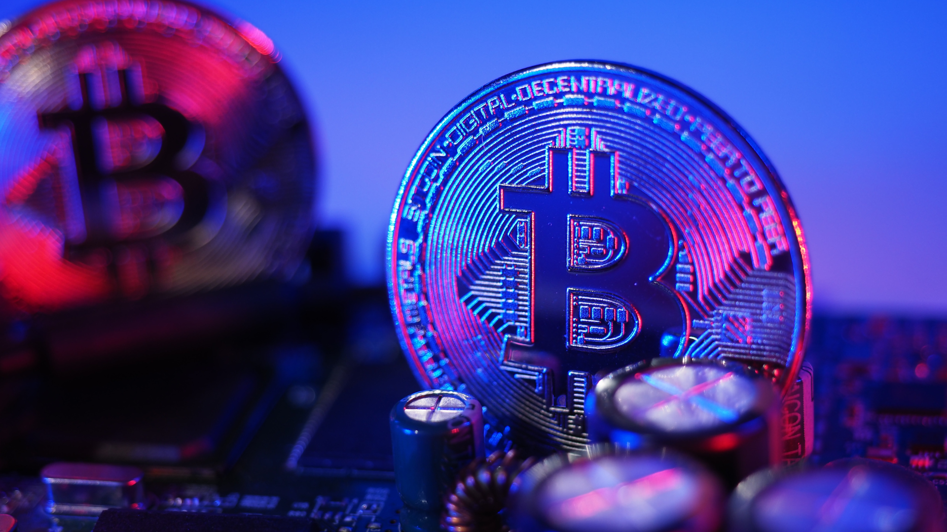 A couple of XRP tokens floating in the air on a purple background.
