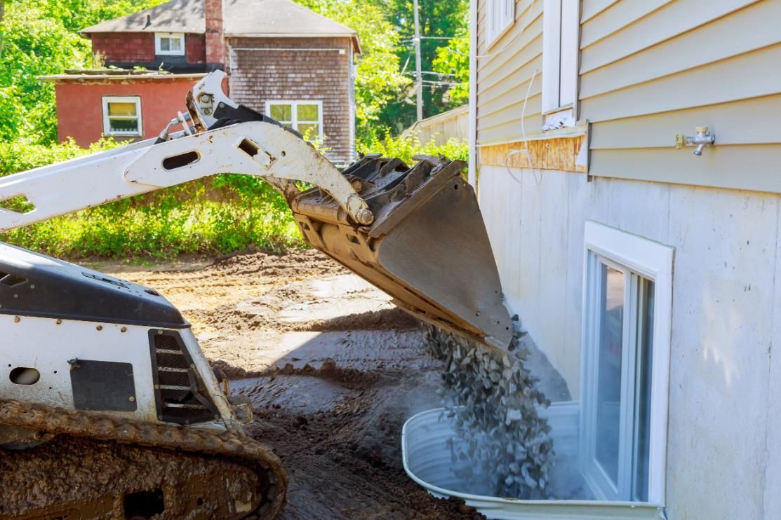 A Bulldozer is Loading Dirt Into a House — Matt's Mini Machines in Bli Bli, QLD