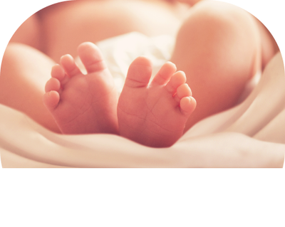 A close up of a baby 's feet on a bed