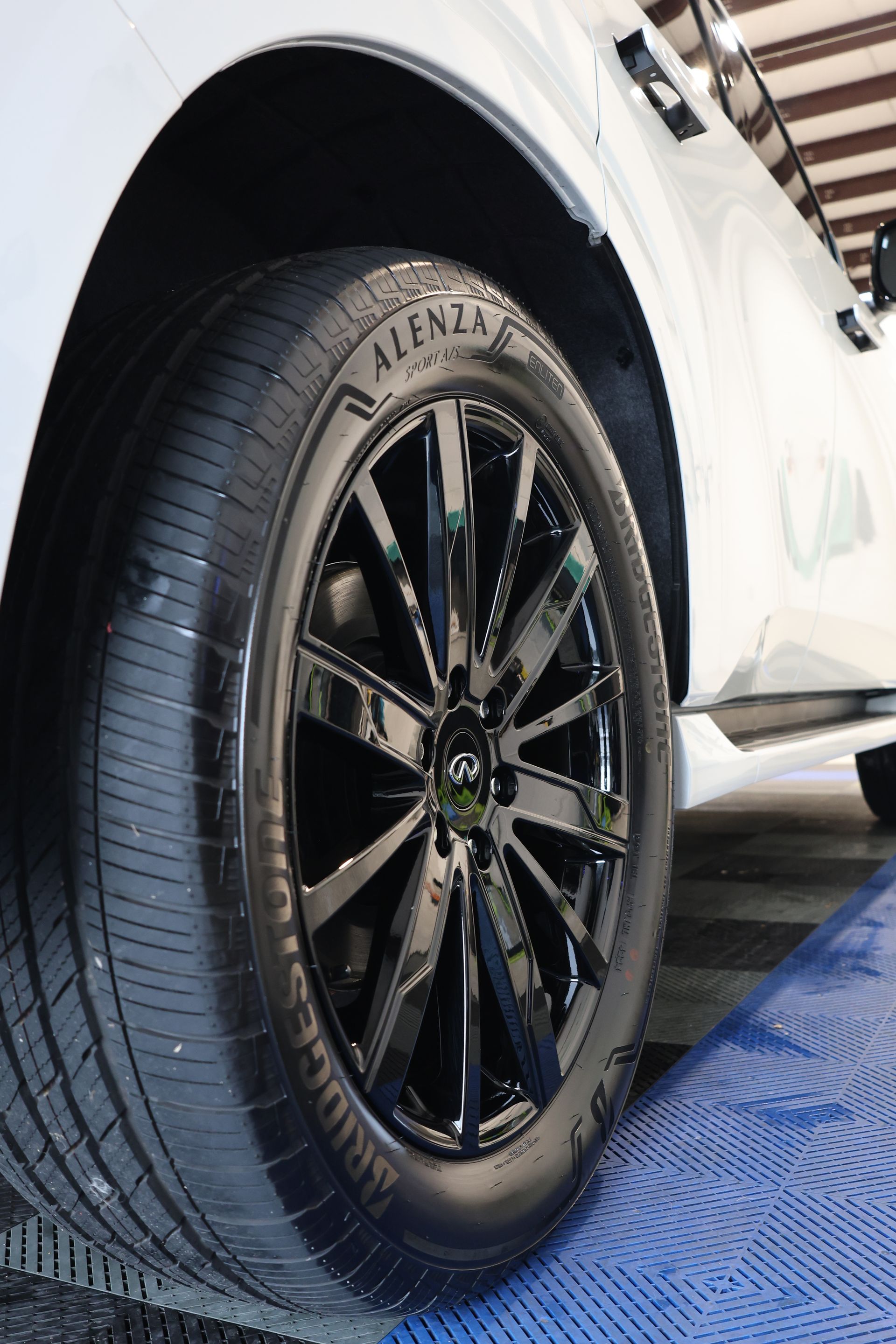 A person is cleaning a car with a red towel.