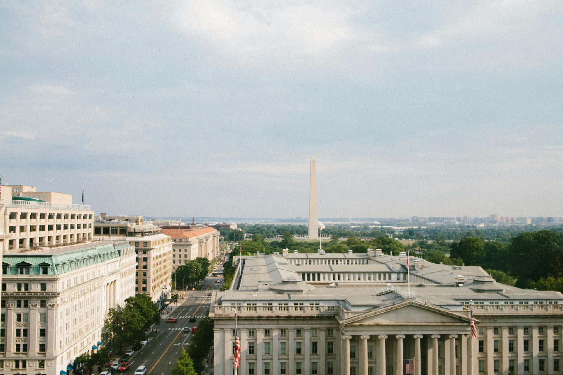 An aerial view of washington d.c. with the washington monument in the background.