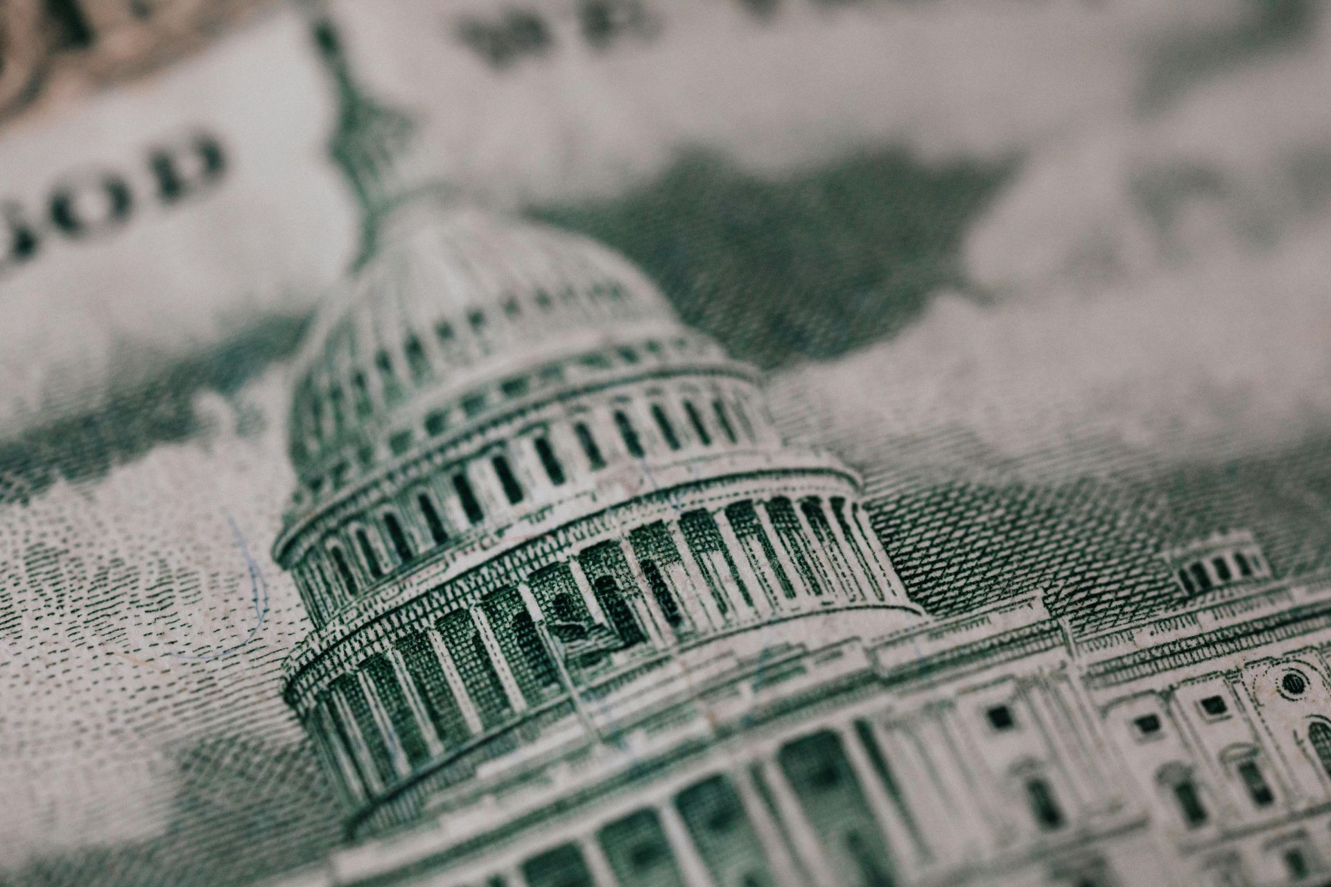 A close up of a dollar bill with a picture of the capitol building on it.